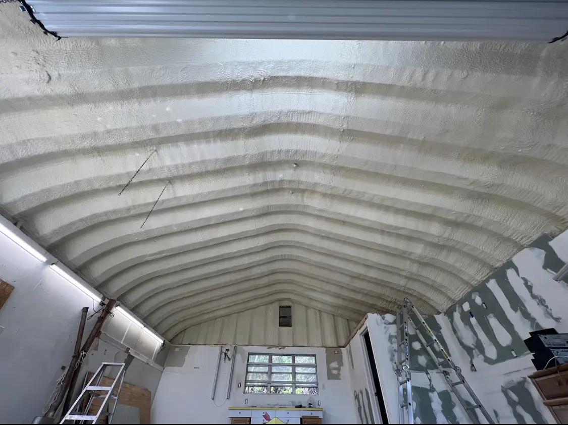 Spray polyurethane foam applied to the underside of a metal roof deck in Snyder